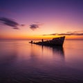 Silhouette of a Shipwreck at Sunset Over Calm Ocean Royalty Free Stock Photo