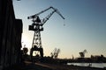 Silhouette of  shipyard`s tall crane. Royalty Free Stock Photo