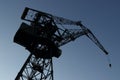 Silhouette of shipyard`s tall crane. Royalty Free Stock Photo