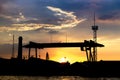 silhouette of the shipyard with sunset / sun rise screen background Royalty Free Stock Photo