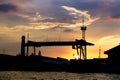 A silhouette of Shipyard with sunset / sun rise screen background Royalty Free Stock Photo