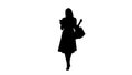 Silhouette Shopping woman with bags texting message on smartphon