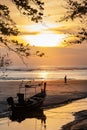 Silhouette shot of fishing boat on the beach during sunset Royalty Free Stock Photo