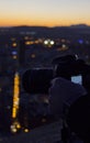 Silhouette shot of a man holding a camera with a blurred background Royalty Free Stock Photo