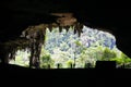 A silhouette shot at the mouth of a cave