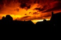 Silhouette shot of old houses in a town against a fiery evening sky in Handschuhsheim, Germany