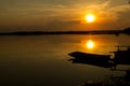 Silhouette shot, Sunset with boat over lake or pond or swamp o Royalty Free Stock Photo