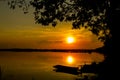 Silhouette shot, Sunset with boat and tree over lake or pond o Royalty Free Stock Photo