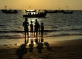 Silhouette shot of young people at the beach during sunset