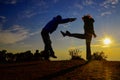 Silhouette Show the fight: Woman lift her leg and kick him to the tummy of a man at the mountain against the sunset Royalty Free Stock Photo