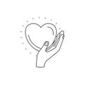 Silhouette side view of hand holding in palm a heart charity symbol