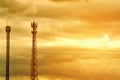 Silhouette signal antenna tower at sunset sky background. Royalty Free Stock Photo