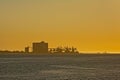 Silhouette of Silo`s and cranes against golden sunset sky in the port of Lisbon Royalty Free Stock Photo