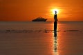 Silhouette of single Asian girl enjoying herself during sunset on the beach red sky Royalty Free Stock Photo