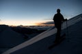 Silhouette of a skier climbing a snowy slope and admiring the peaks of the mountains Royalty Free Stock Photo