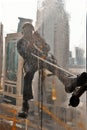 Silhouette of Skyscraper window Cleaner washing a window in Doha, Qatar Royalty Free Stock Photo