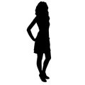 Silhouette of slim beautiful woman girl with long legs clothed in cocktail dress and high heels, standing with hands on her hips Royalty Free Stock Photo