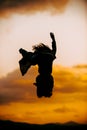 Modern style silhouette woman dancer jumping on sunset Royalty Free Stock Photo