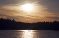 Silhouette of small boat in golden sunset. Royalty Free Stock Photo