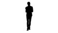 Silhouette Smiling businessman using digital tablet while walkin