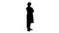 Silhouette Smiling confident young woman doctor standing with arms crossed over. Royalty Free Stock Photo