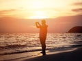 Silhouette smiling woman taking photograph on the beach Royalty Free Stock Photo