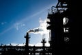 Silhouette of smokestack in petrochemical plant Royalty Free Stock Photo