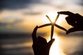 Silhouette and Soft focus on woman hand holding starfish Royalty Free Stock Photo