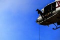 Silhouette Soldier Jump rope from helicopter in blue sky Royalty Free Stock Photo