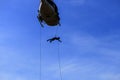 Silhouette Soldier Jump rope from helicopter in blue sky Royalty Free Stock Photo