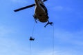 Silhouette Soldier Jump rope from helicopter in blue sky Royalty Free Stock Photo