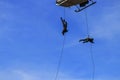 Silhouette Soldier Jump rope from helicopter in blue sky Royalty Free Stock Photo