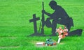 Silhouette of Soldier Kneeling in Veterans Cemetery Royalty Free Stock Photo