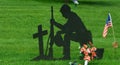 Silhouette of Soldier Kneeling by Grave with Cross.S. Official Navy Seal on Wall Royalty Free Stock Photo