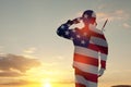 Silhouette of soldier with pattern USA flag saluting. Greeting card for Veterans Day, Memorial Day, Independence Day. Royalty Free Stock Photo