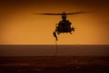 Silhouette of soldier repelling from a helicopter