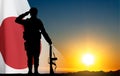 Silhouette of a soldier saluting on background of susnset with Japan flag