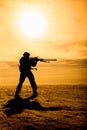 Silhouette of soldier with sniper rifle