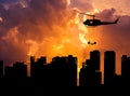 Silhouette soldiers in action rappelling climb down from helicopter in building skyscraper on sunset Royalty Free Stock Photo