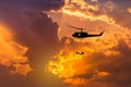 Silhouette soldiers in action rappelling climb down from helicopter with military mission counter terrorism Royalty Free Stock Photo