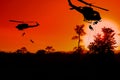 Silhouette Soldiers rappel down to attack from helicopter with sunset Royalty Free Stock Photo