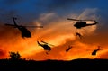 Silhouette Soldiers rappel down to attack from helicopter with sunset Royalty Free Stock Photo