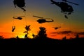 Silhouette Soldiers rappel down to attack from helicopter with sunset Royalty Free Stock Photo