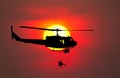 Silhouette Soldiers rappel down to attack from helicopter with warrior beware danger On the ground sunset Background blur Royalty Free Stock Photo