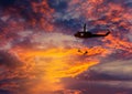 Silhouette soldiers in rappelling climb down from helicopter with military mission counter terrorism assault training on su