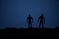 Silhouette some zombies on the cemetery walking around at sunset. Selective focus Royalty Free Stock Photo