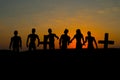 Silhouette some zombies on the cemetery walking around at sunset Royalty Free Stock Photo