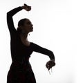 Silhouette of spanish girl flamenco dancer on a light background. free space for your text Royalty Free Stock Photo