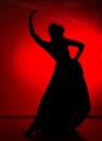 Silhouette of spanish girl flamenco dancer on a red background Royalty Free Stock Photo