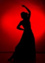 Silhouette of spanish girl flamenco dancer on a red background